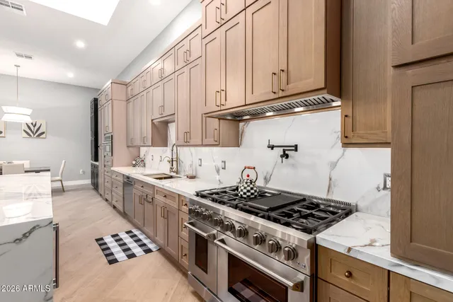 a kitchen with stainless steel appliances a refrigerator and cabinets