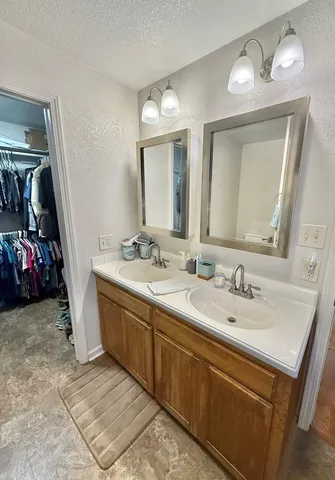 a bathroom with 2 sink and a mirror