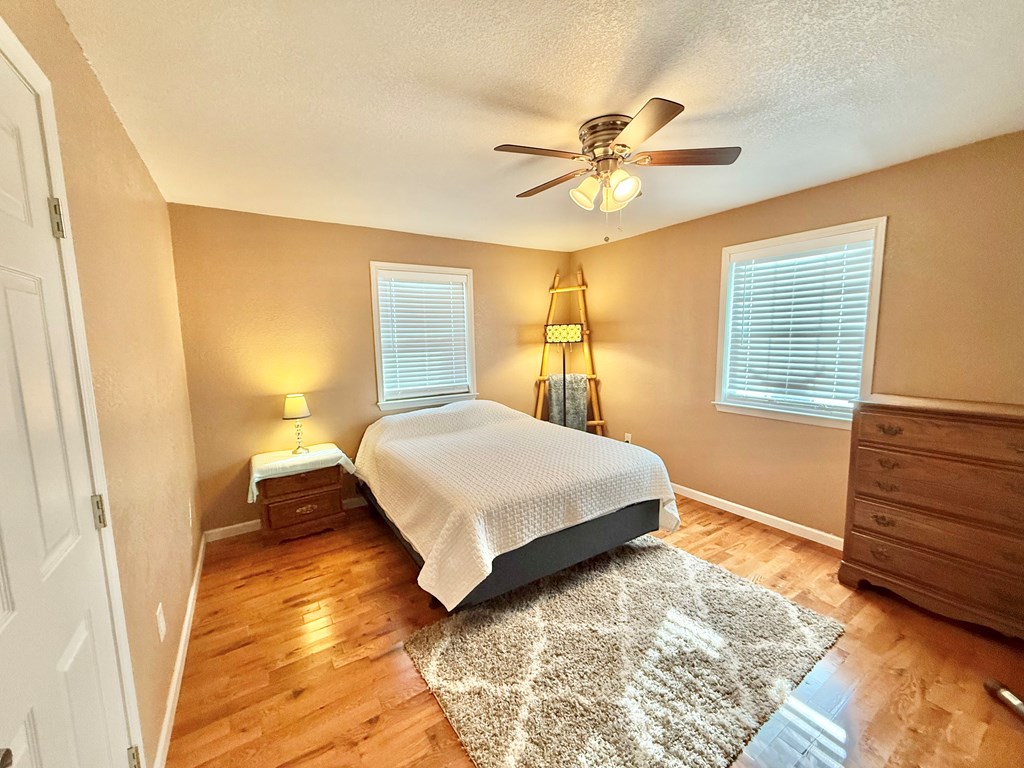 281 Oak Road Harper, TX 78631 - Photo 8 of 22 a bedroom with a bed and a chandelier