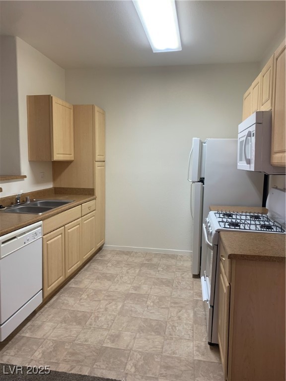 8250 North Grand Canyon Drive, Unit 1158 Las Vegas, NV 89166 - Photo 12 of 40 Kitchen featuring light brown cabinetry, stove, dishwasher, dark countertops, and stone finish floors