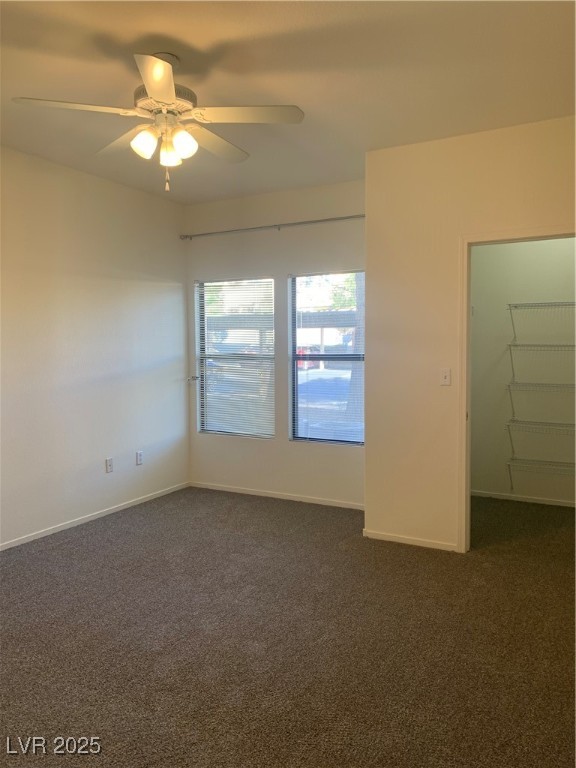 8250 North Grand Canyon Drive, Unit 1158 Las Vegas, NV 89166 - Photo 14 of 40 Empty room featuring dark carpet and a ceiling fan