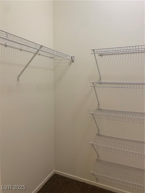 8250 North Grand Canyon Drive, Unit 1158 Las Vegas, NV 89166 - Photo 19 of 40 Spacious closet featuring dark carpet