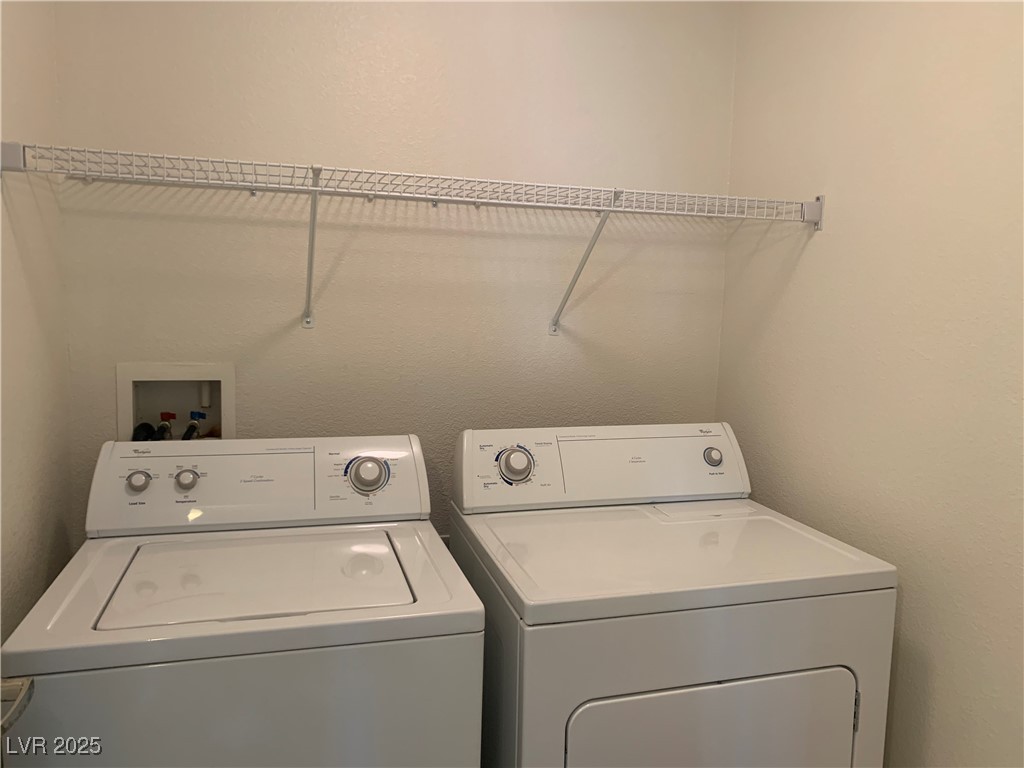 8250 North Grand Canyon Drive, Unit 1158 Las Vegas, NV 89166 - Photo 28 of 40 Laundry area featuring a textured wall and washer and dryer