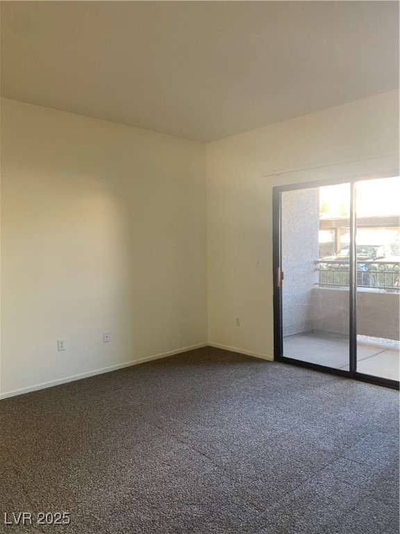 8250 North Grand Canyon Drive, Unit 1158 Las Vegas, NV 89166 - Photo 8 of 40 Spare room with dark colored carpet and baseboards