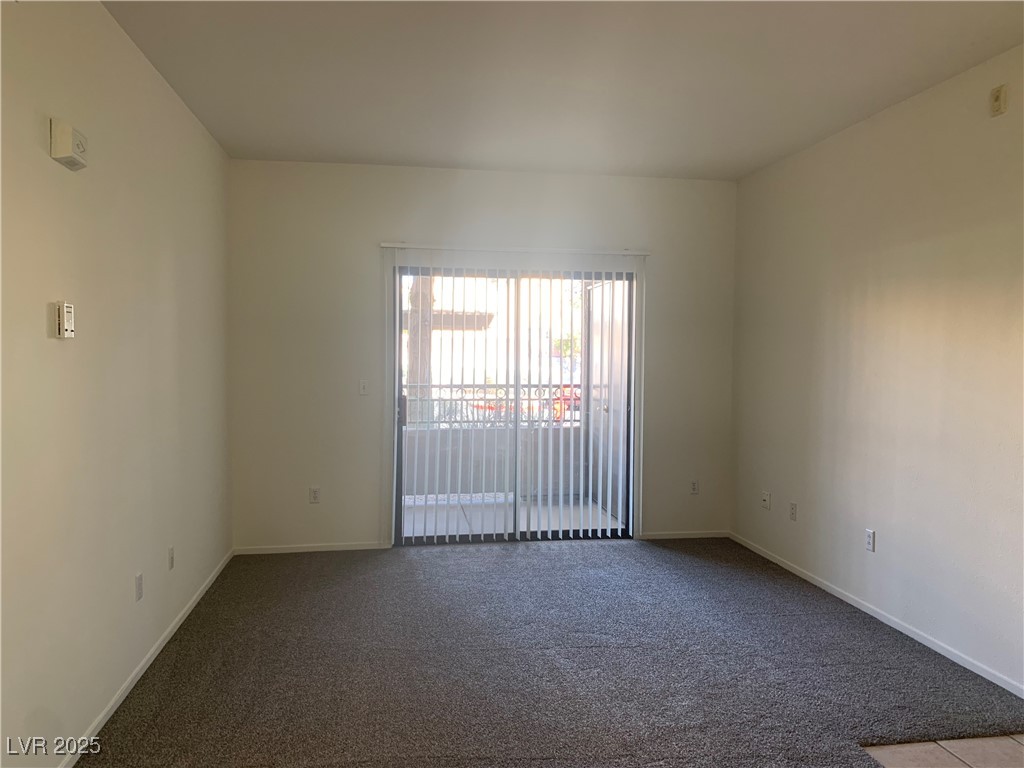8250 North Grand Canyon Drive, Unit 1158 Las Vegas, NV 89166 - Photo 9 of 40 Empty room with dark colored carpet