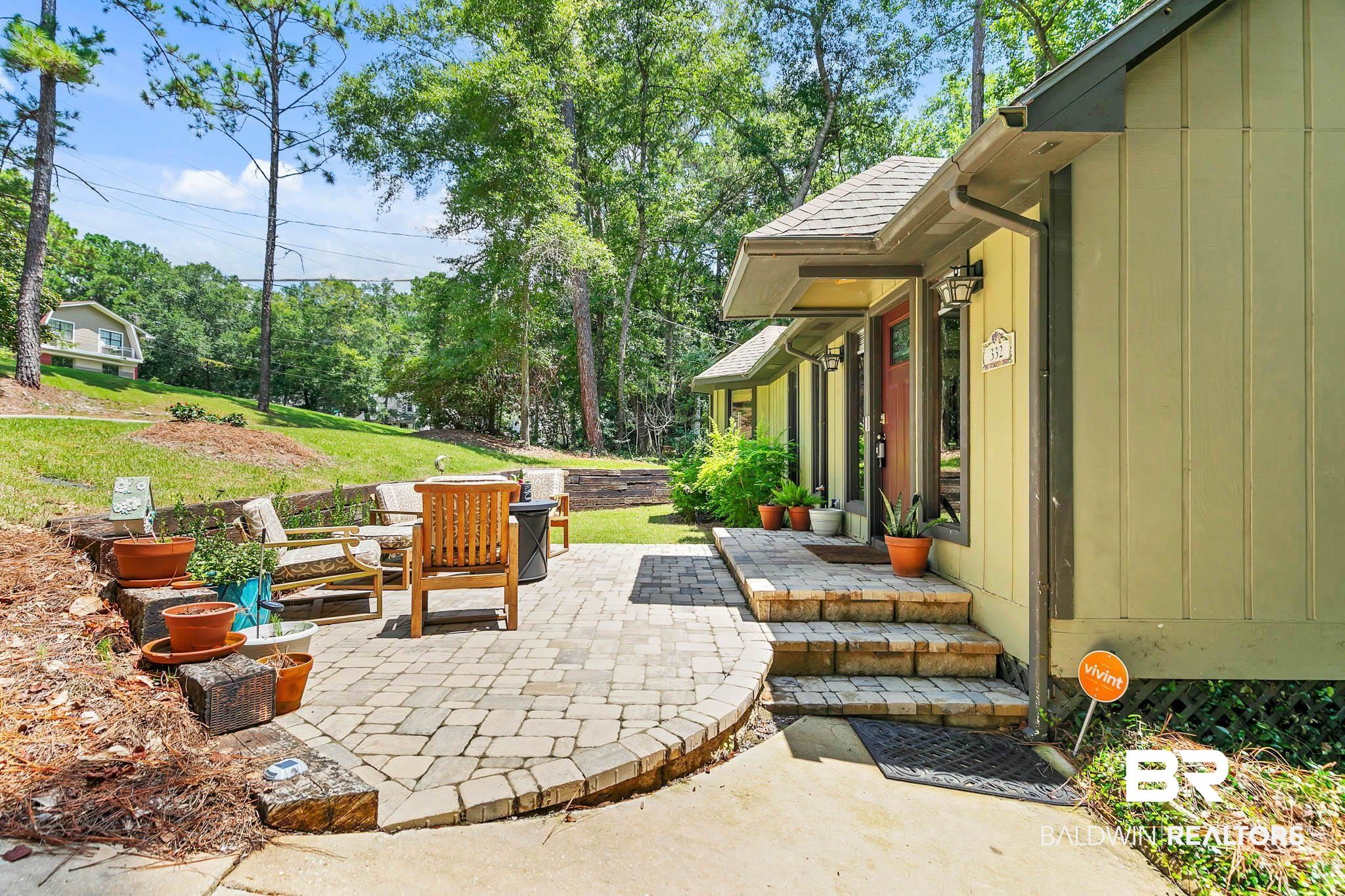332 Ridgewood Drive Daphne, AL 36526 - Photo 5 of 48 View of patio with view of wooded area