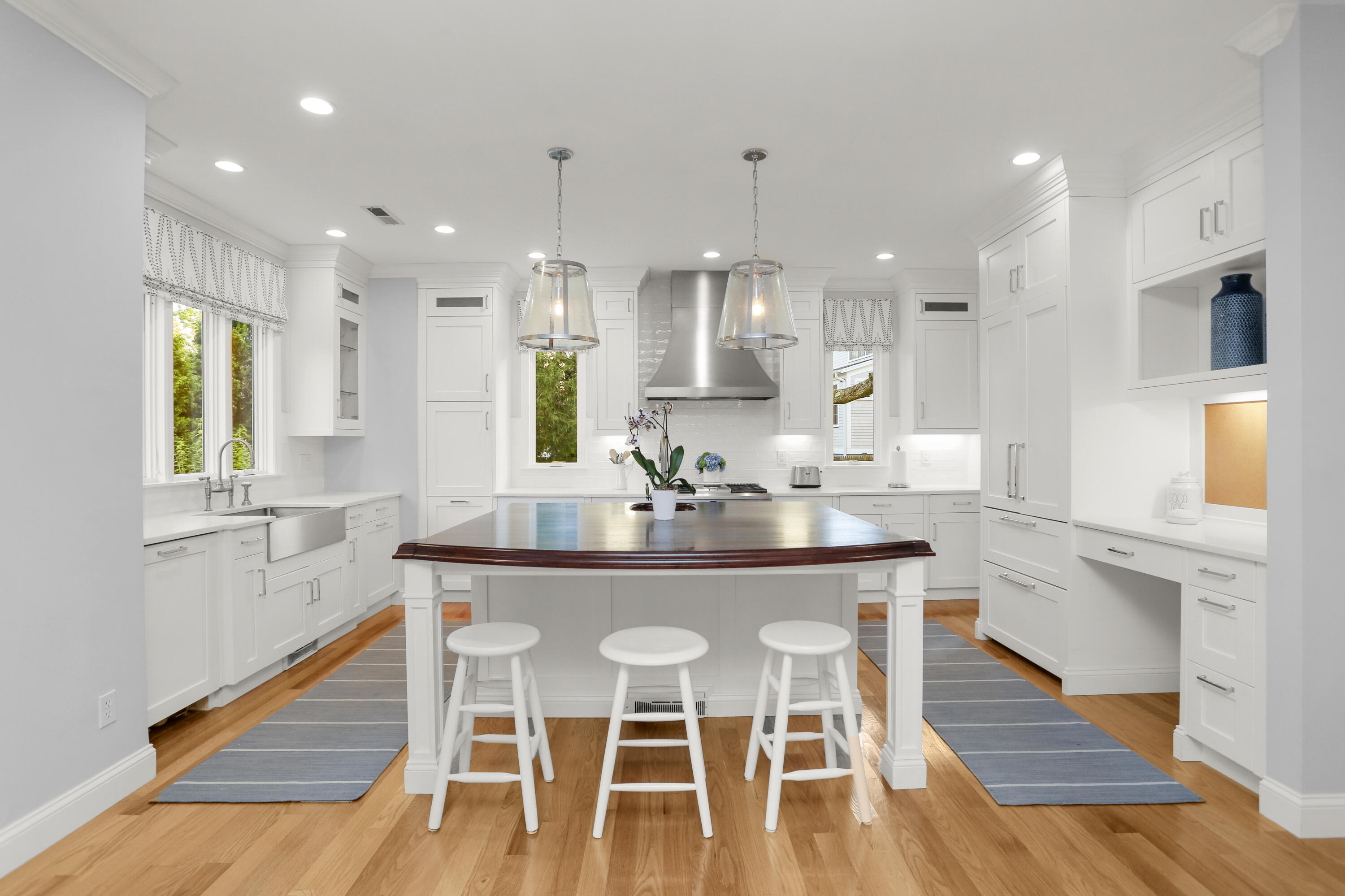 12 Richmond Road Norwalk, CT 06853 - Photo 13 of 40 a kitchen with stainless steel appliances a dining table chairs sink and cabinets