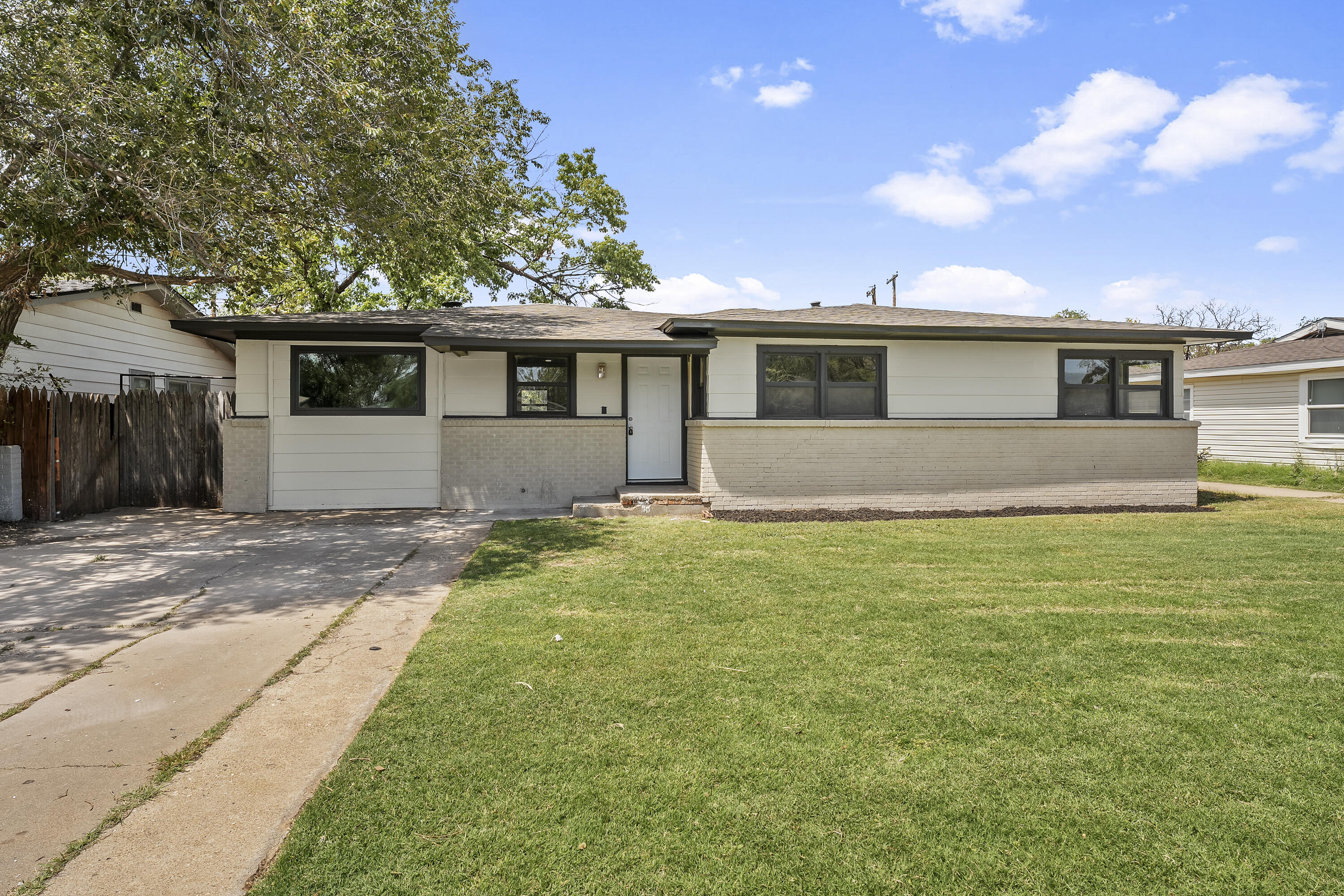 a front view of house with yard and trees