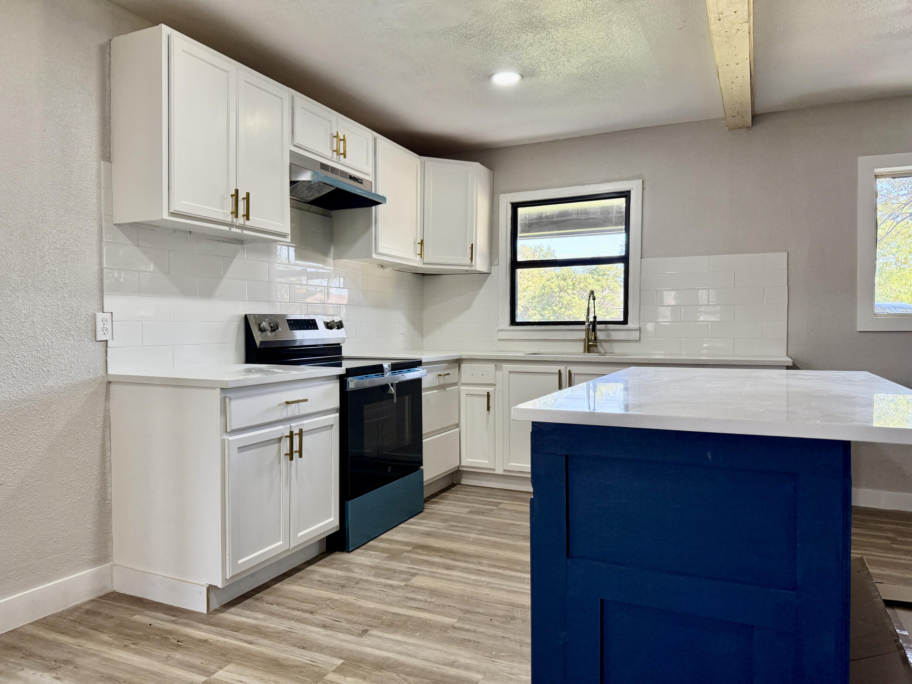 4308 43rd Street Lubbock, TX 79413 - Photo 11 of 28 a kitchen with stainless steel appliances granite countertop a sink stove and microwave