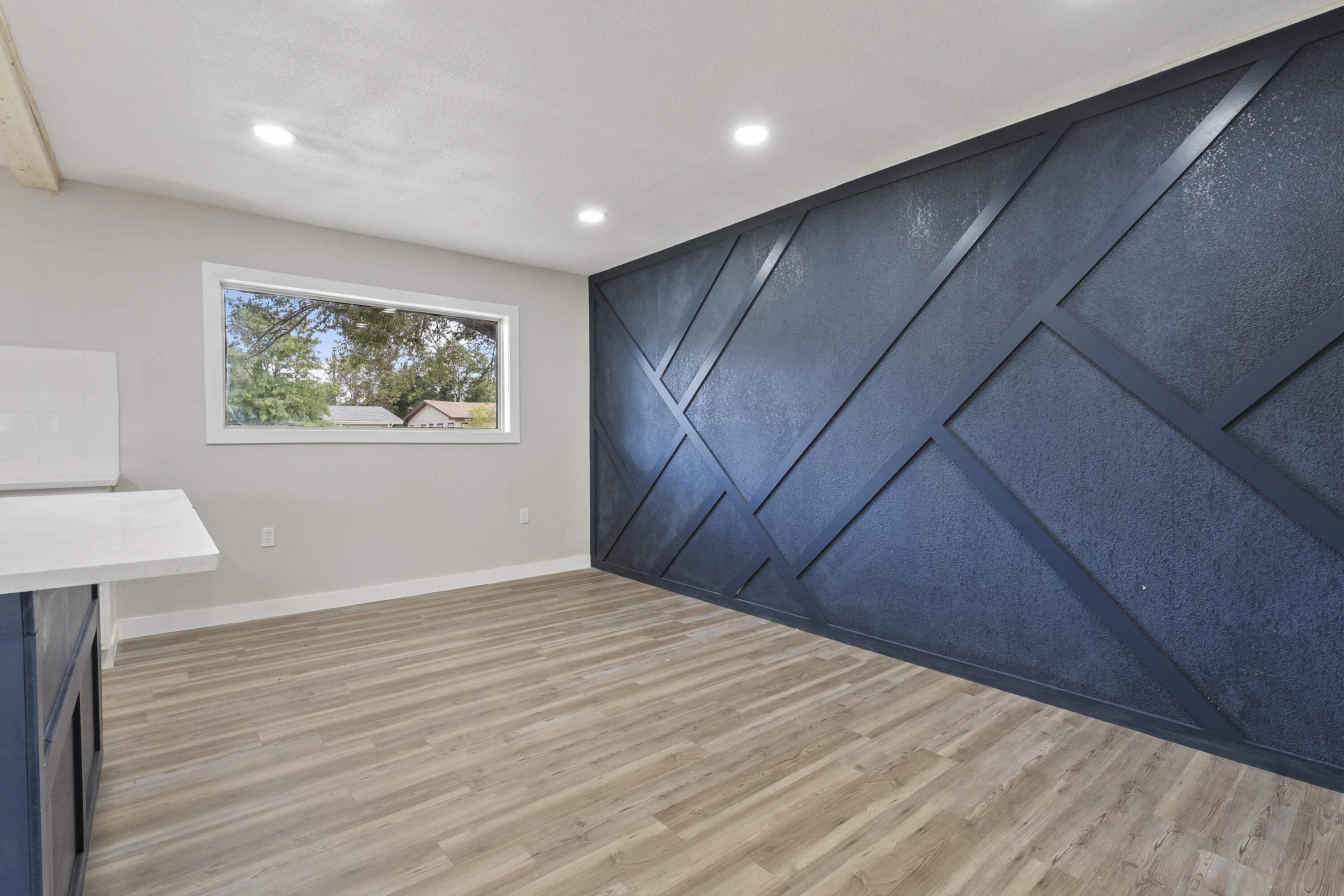 4308 43rd Street Lubbock, TX 79413 - Photo 13 of 28 a view of an empty room with wooden floor and a window