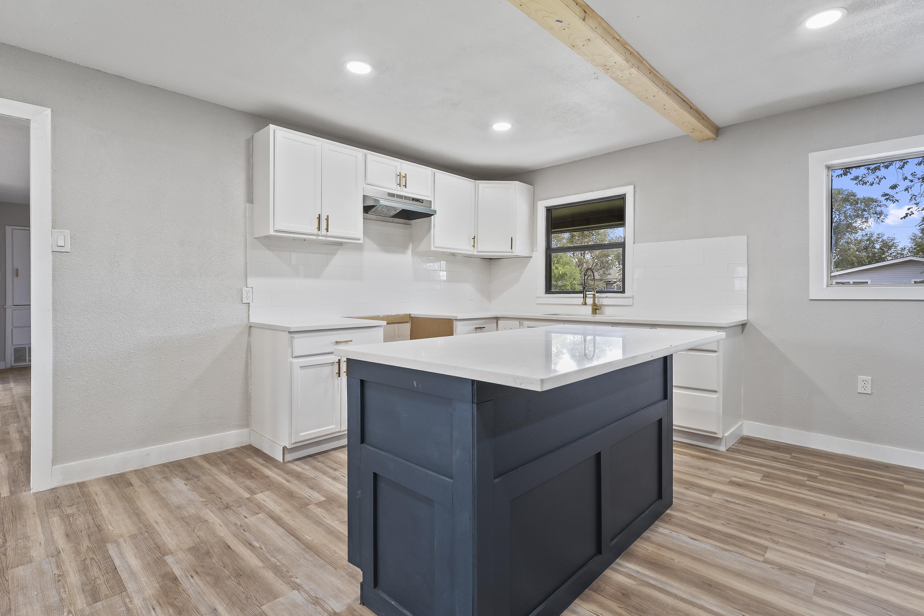 4308 43rd Street Lubbock, TX 79413 - Photo 15 of 28 a kitchen with stainless steel appliances granite countertop a sink stove and wooden floor
