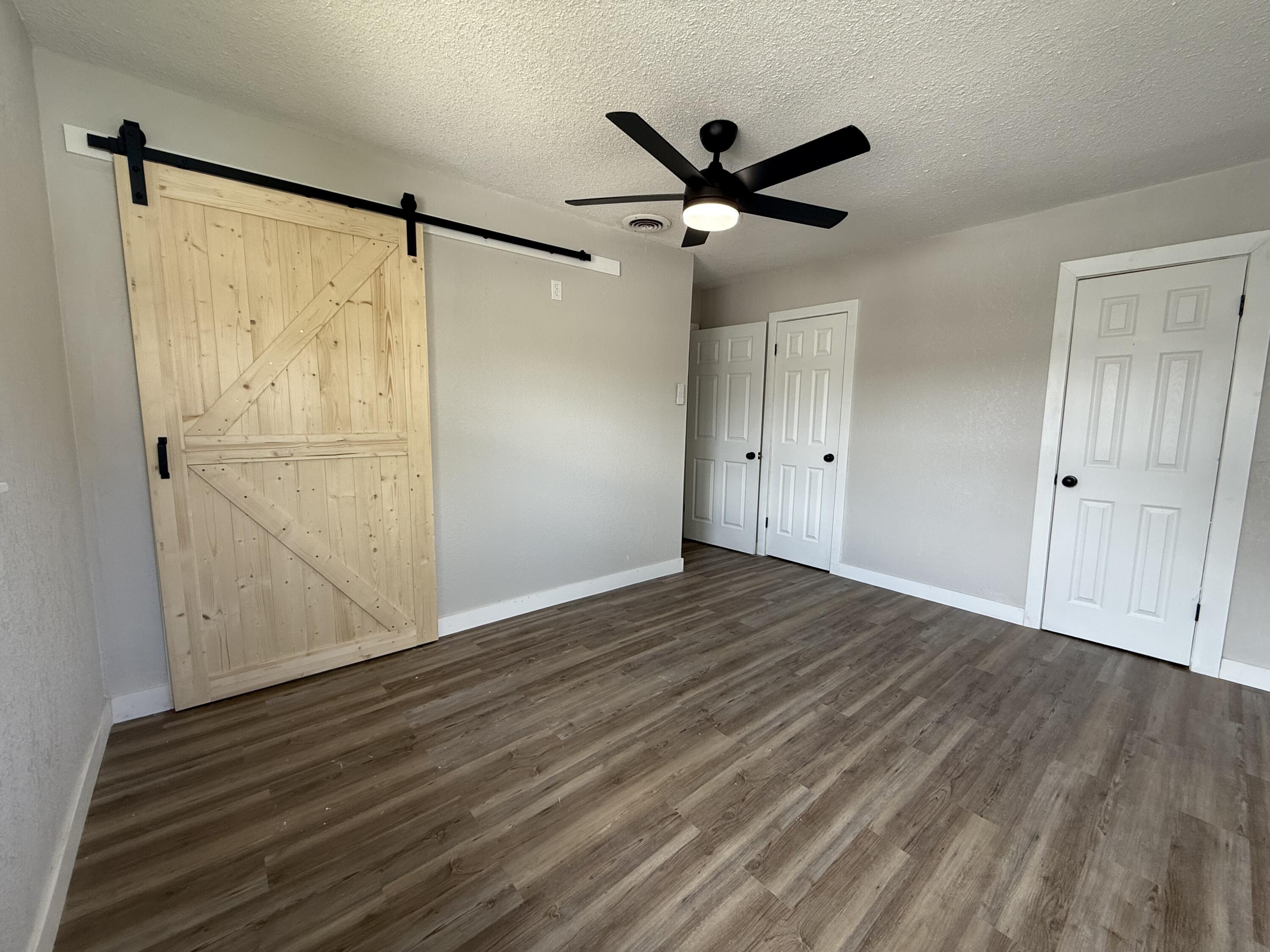 4308 43rd Street Lubbock, TX 79413 - Photo 17 of 28 a view of empty room with wooden floor and fan