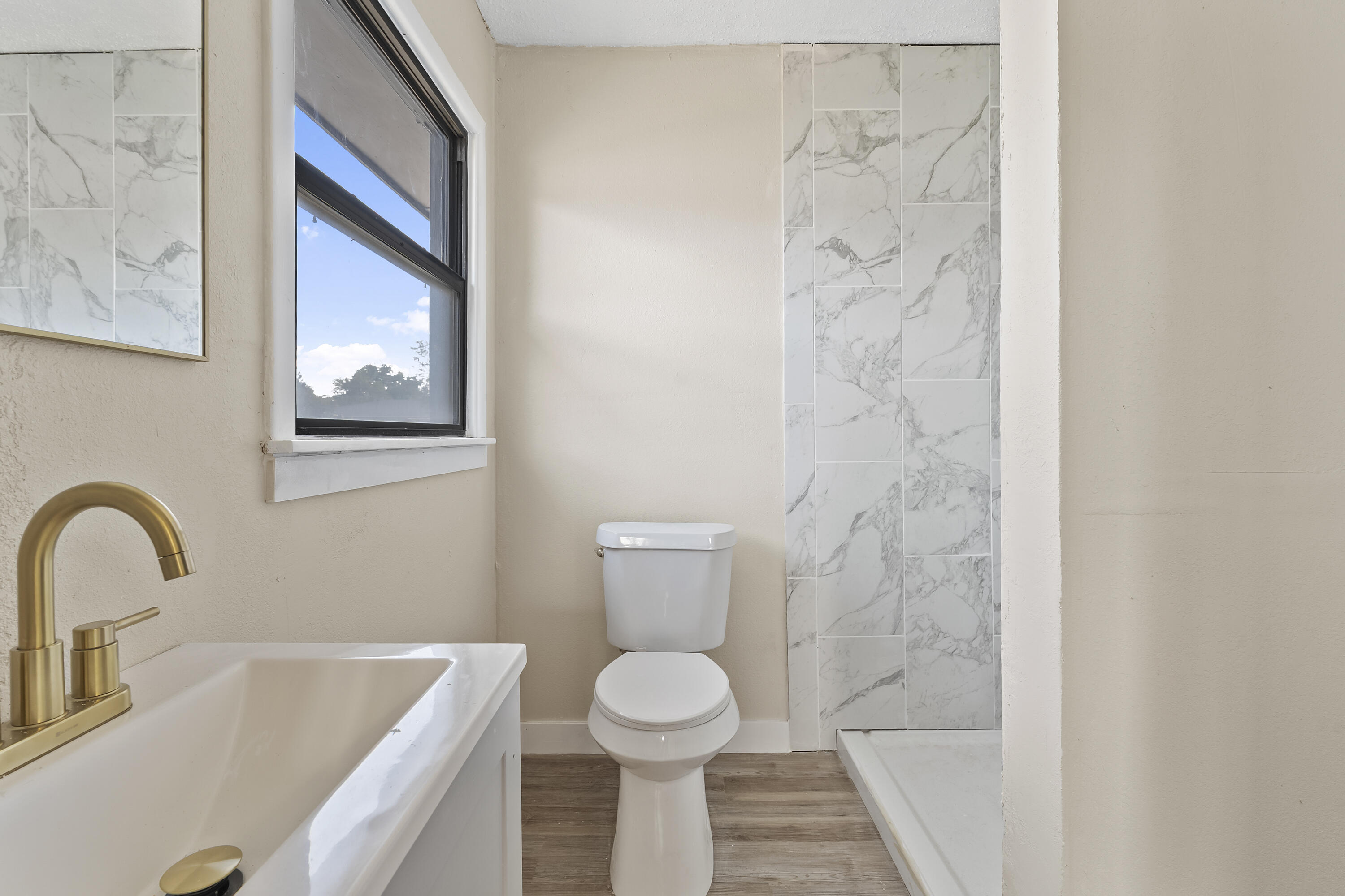 4308 43rd Street Lubbock, TX 79413 - Photo 18 of 28 a bathroom with a sink and a toilet