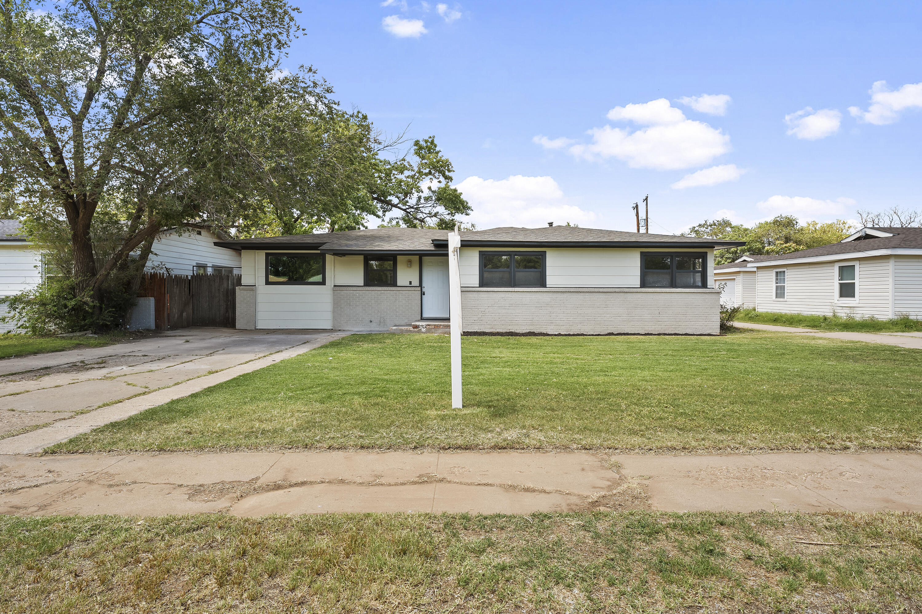 4308 43rd Street Lubbock, TX 79413 - Photo 2 of 28 a front view of a house with garden