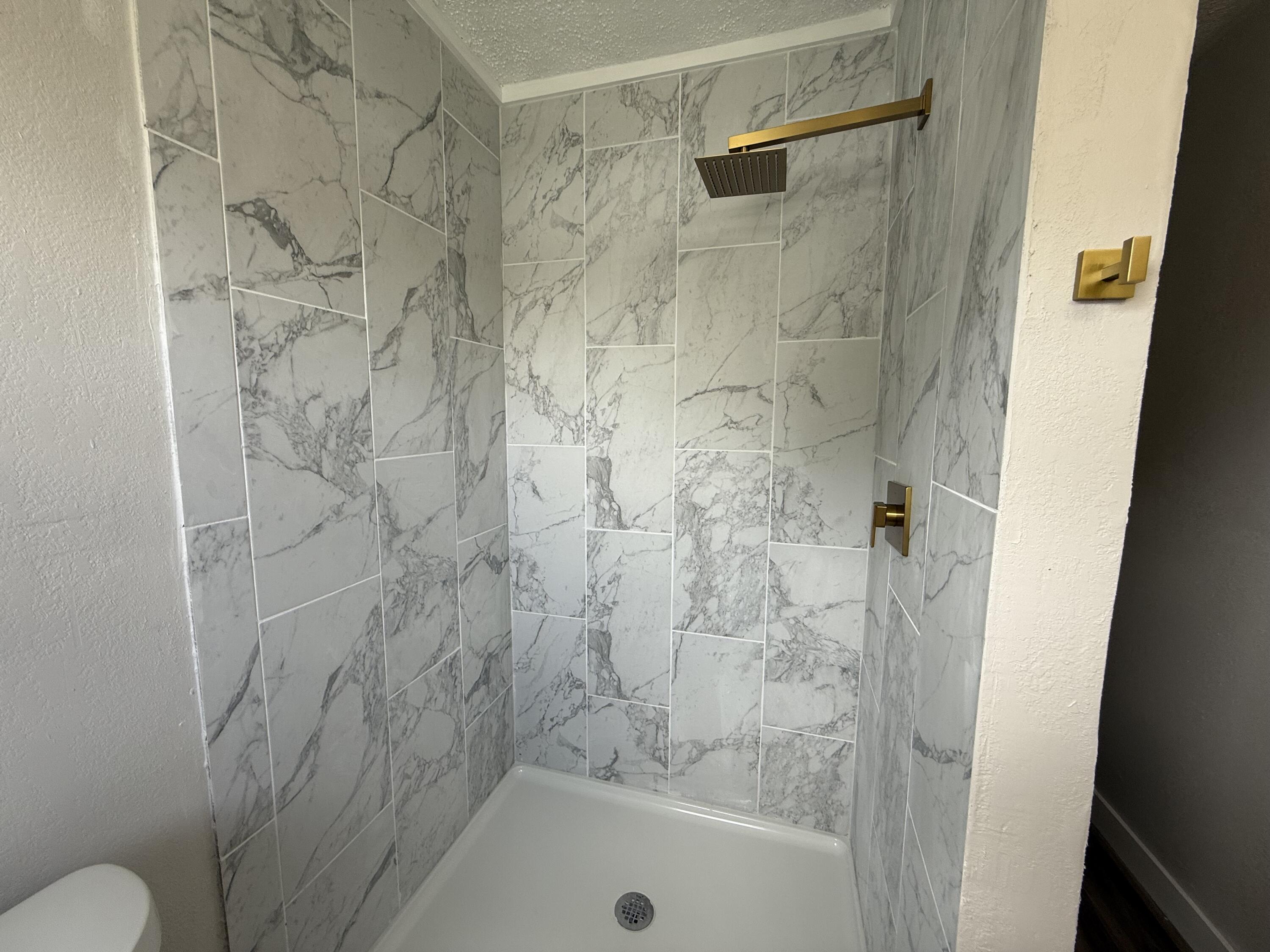 4308 43rd Street Lubbock, TX 79413 - Photo 21 of 28 a bathroom with a shower and a toilet