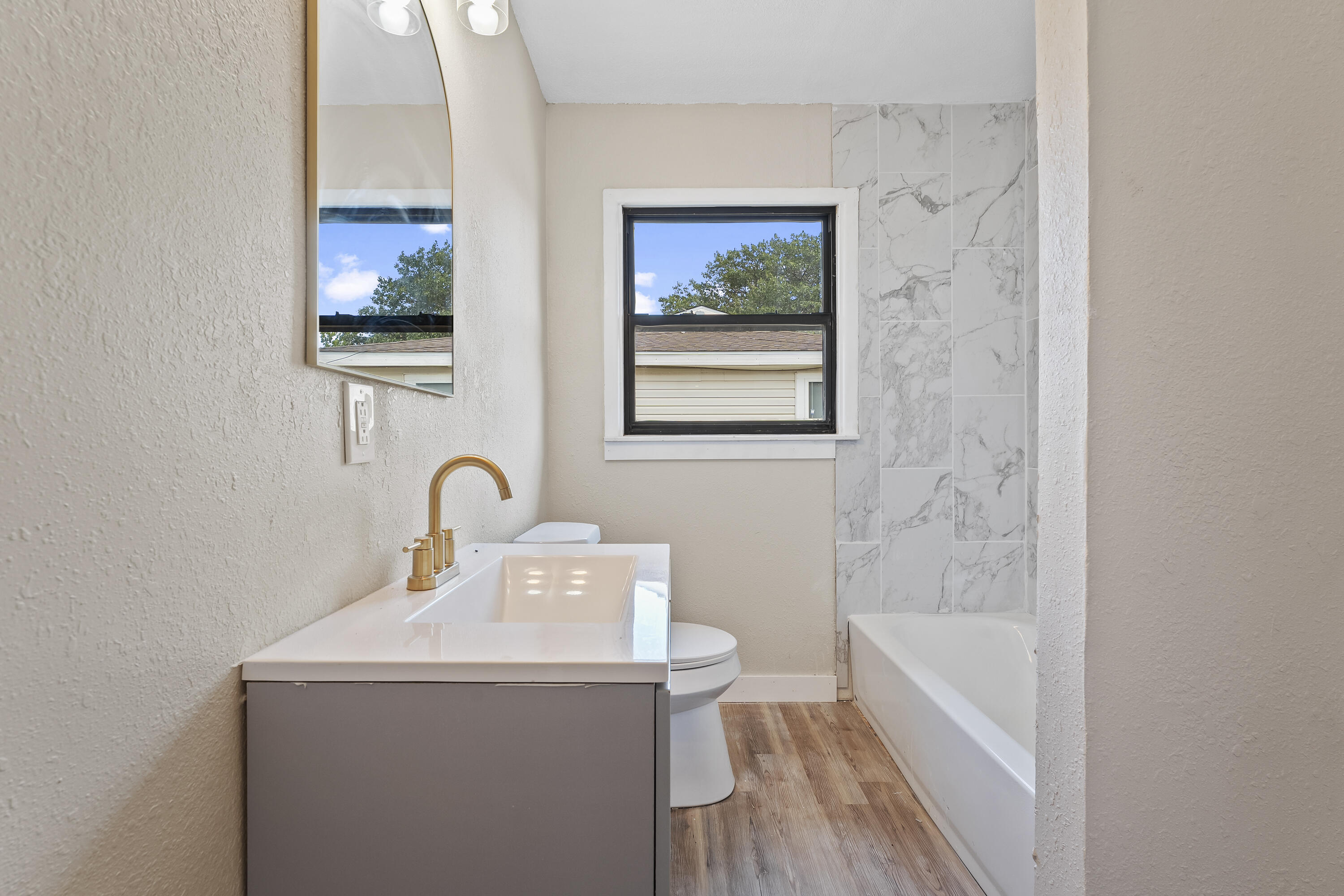 4308 43rd Street Lubbock, TX 79413 - Photo 24 of 28 a bathroom with a sink and a bathtub