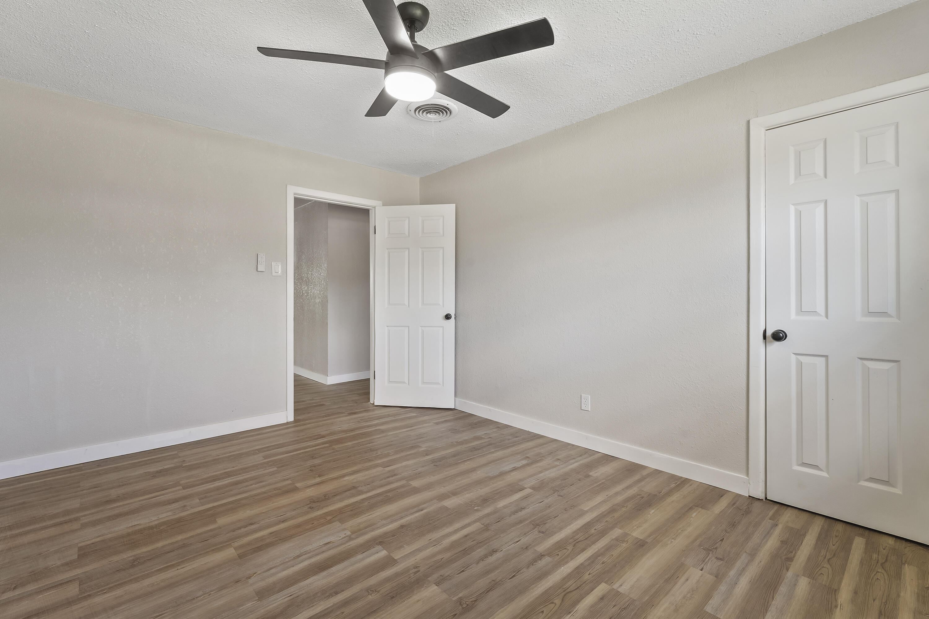 4308 43rd Street Lubbock, TX 79413 - Photo 26 of 28 an empty room with wooden floor and ceiling fan