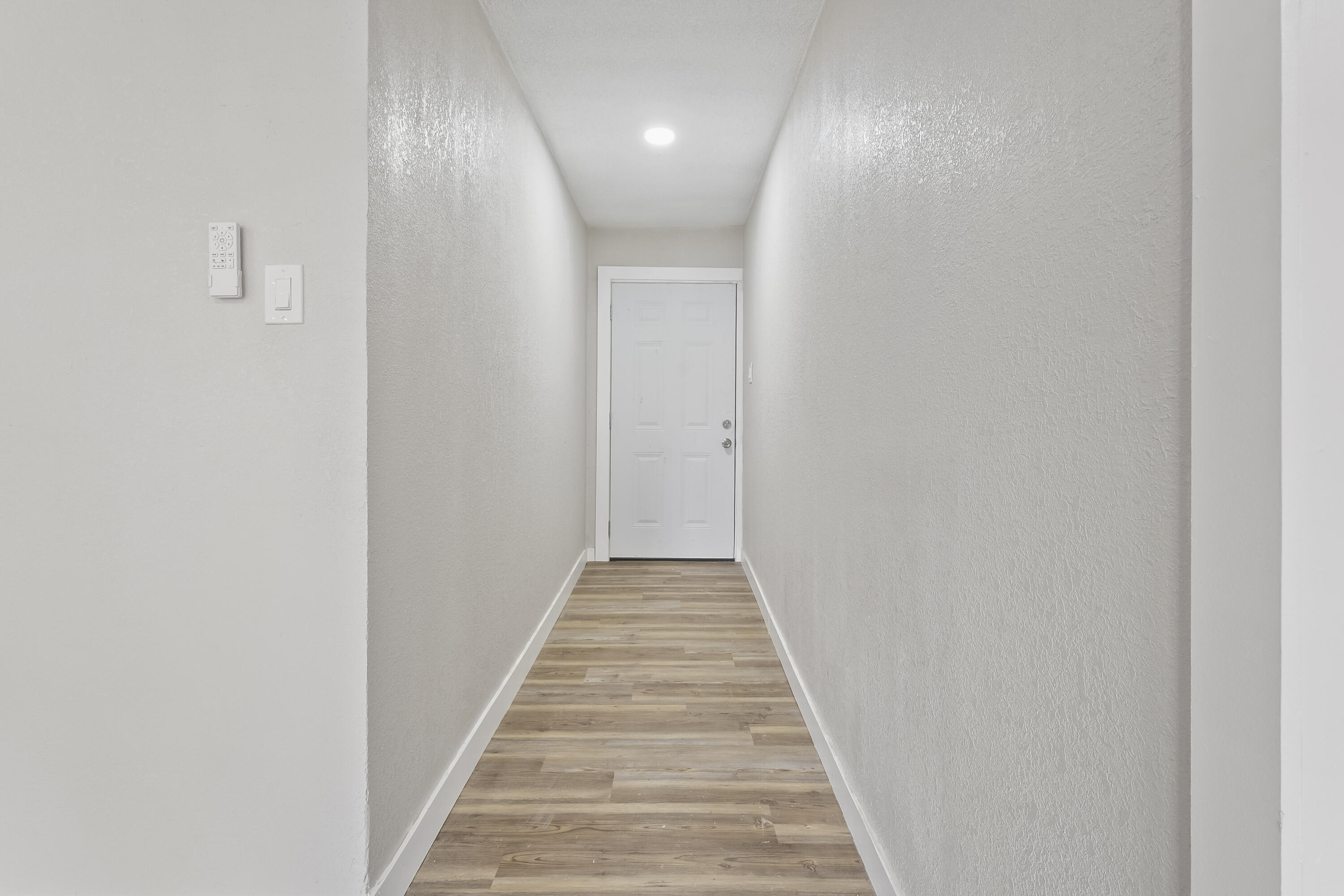 4308 43rd Street Lubbock, TX 79413 - Photo 4 of 28 a view of a hallway with wooden floor