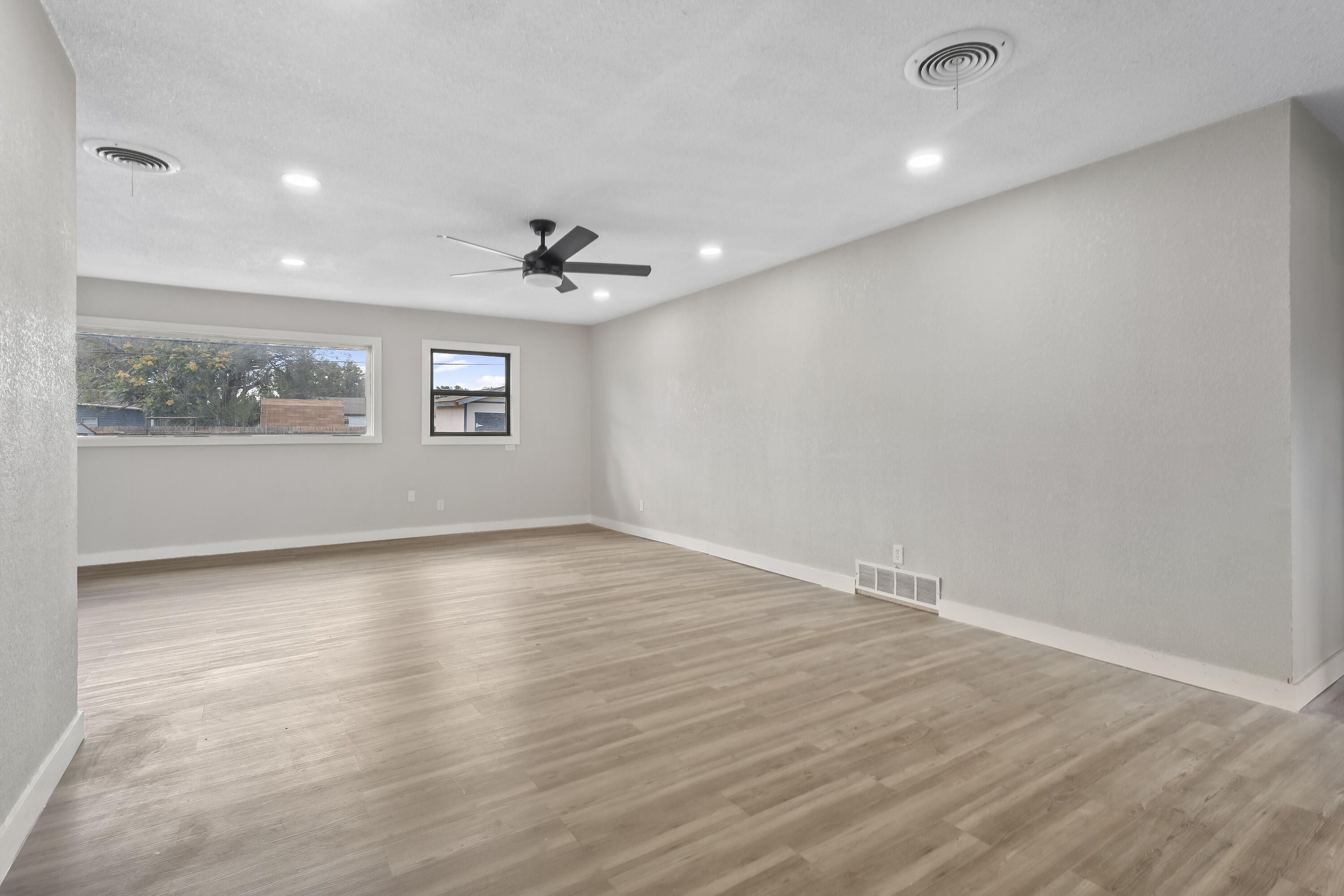 4308 43rd Street Lubbock, TX 79413 - Photo 5 of 28 an empty room with wooden floor and windows