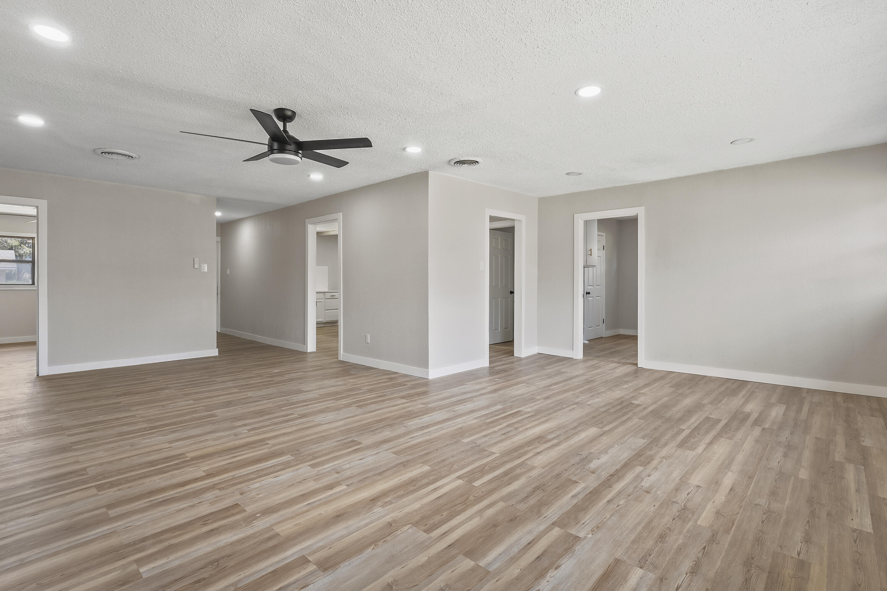 4308 43rd Street Lubbock, TX 79413 - Photo 7 of 28 a view of empty room with wooden floor and ceiling fan