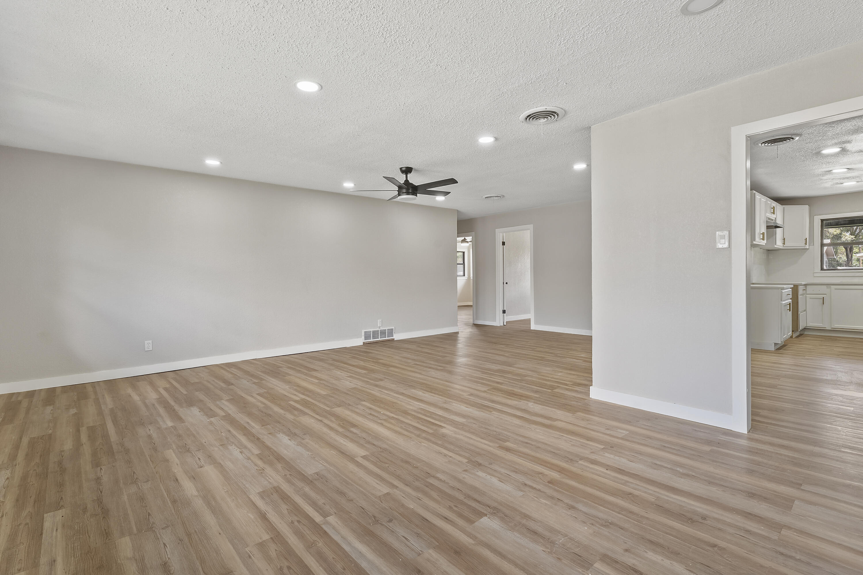 4308 43rd Street Lubbock, TX 79413 - Photo 8 of 28 wooden floor in an empty room with a window
