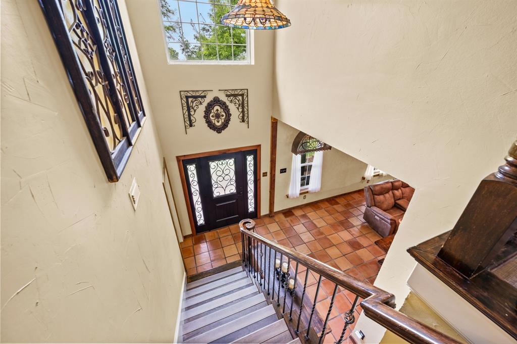2141 Old Denton Road Decatur, TX 76234 - Photo 21 of 40 Two-story foyer featuring a large transom window, and an overhead Tiffany-style pendant light