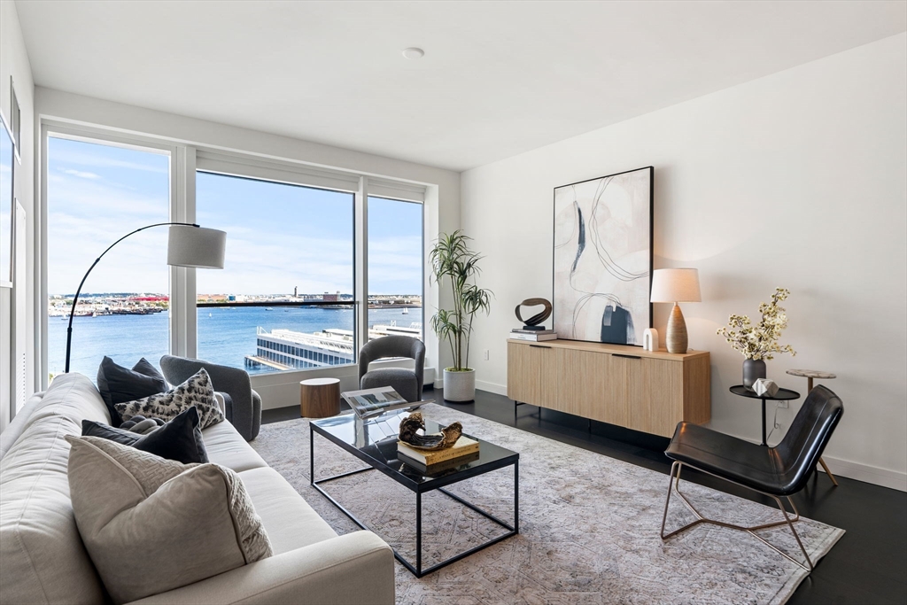150 Seaport, Unit 9C Boston, MA 02210 - Photo 1 of 39 a living room with furniture and a table