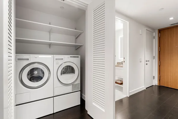 a view of a hallway with washer and dryer