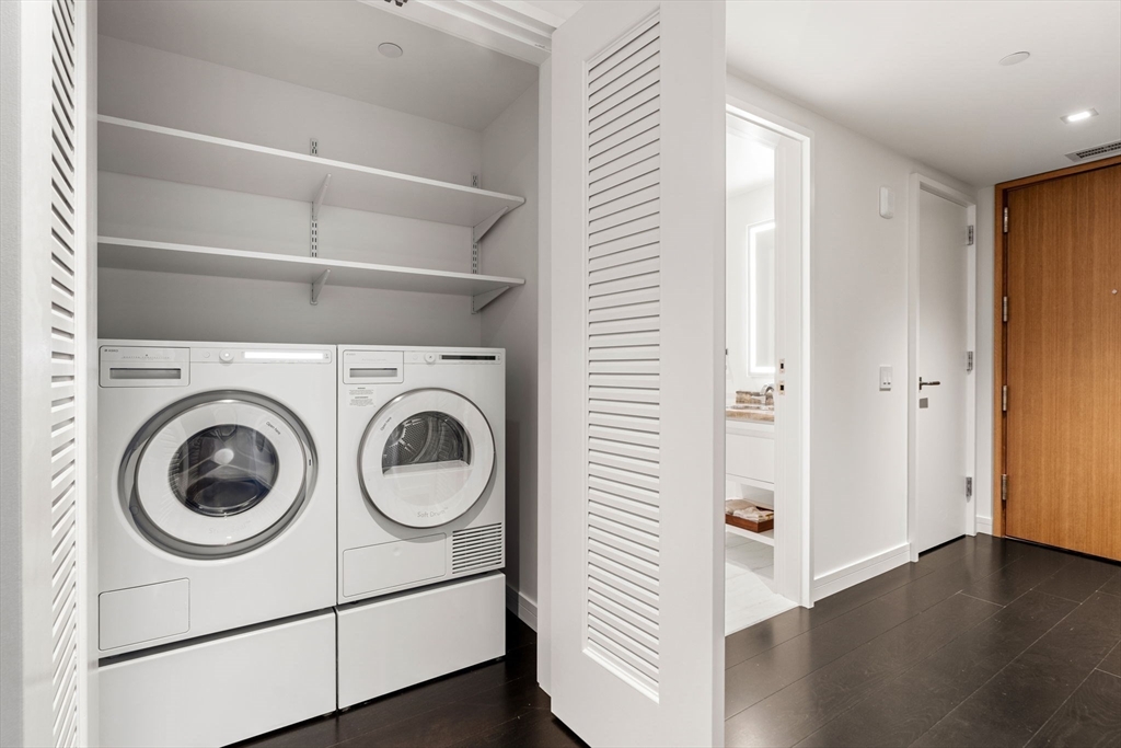 150 Seaport, Unit 9C Boston, MA 02210 - Photo 13 of 39 a view of a hallway with washer and dryer