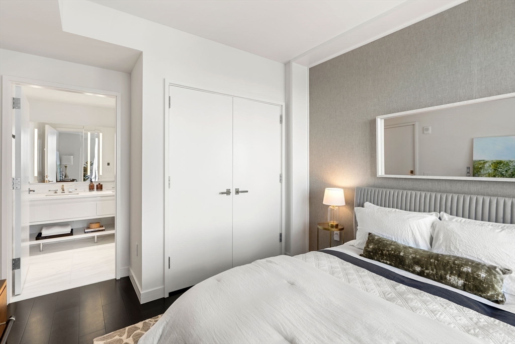 150 Seaport, Unit 9C Boston, MA 02210 - Photo 16 of 39 a bedroom with a bed and a window