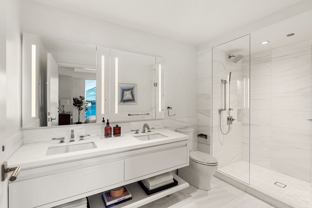 150 Seaport, Unit 9C Boston, MA 02210 - Photo 17 of 39 a bathroom with a sink a toilet and shower