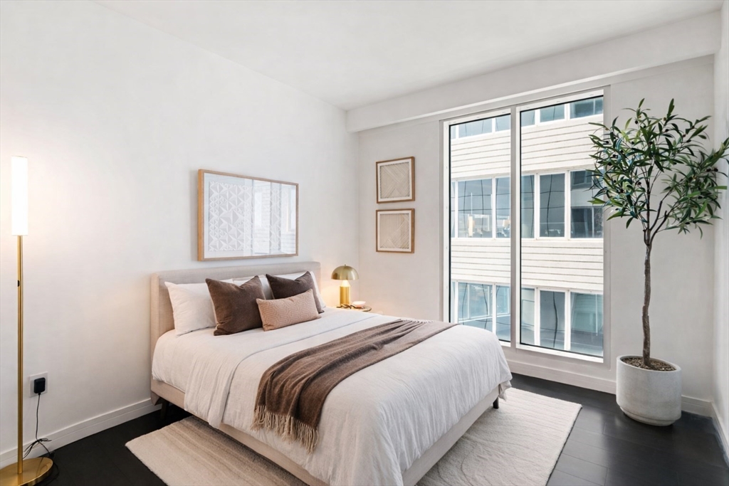 150 Seaport, Unit 9C Boston, MA 02210 - Photo 18 of 39 a bedroom with a large bed and a large window