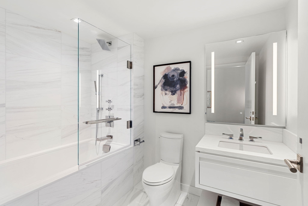 150 Seaport, Unit 9C Boston, MA 02210 - Photo 21 of 39 a bathroom with a sink a toilet and a bathtub