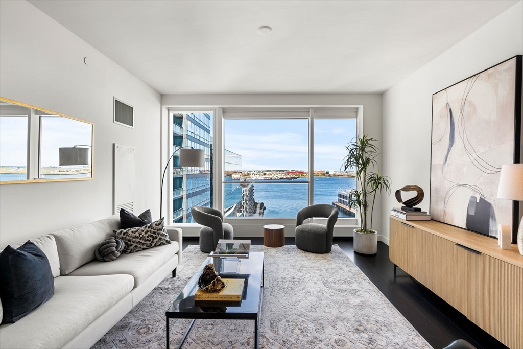 150 Seaport, Unit 9C Boston, MA 02210 - Photo 3 of 39 a living room with furniture and a large window