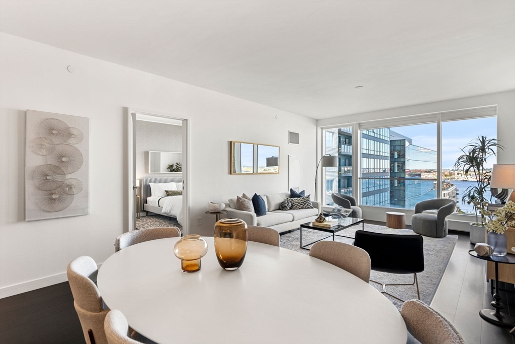 150 Seaport, Unit 9C Boston, MA 02210 - Photo 5 of 39 a living room with furniture and a large window