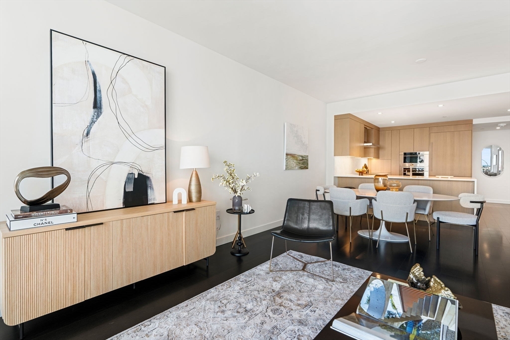 150 Seaport, Unit 9C Boston, MA 02210 - Photo 6 of 39 a living room with lots of furniture and a wooden floor
