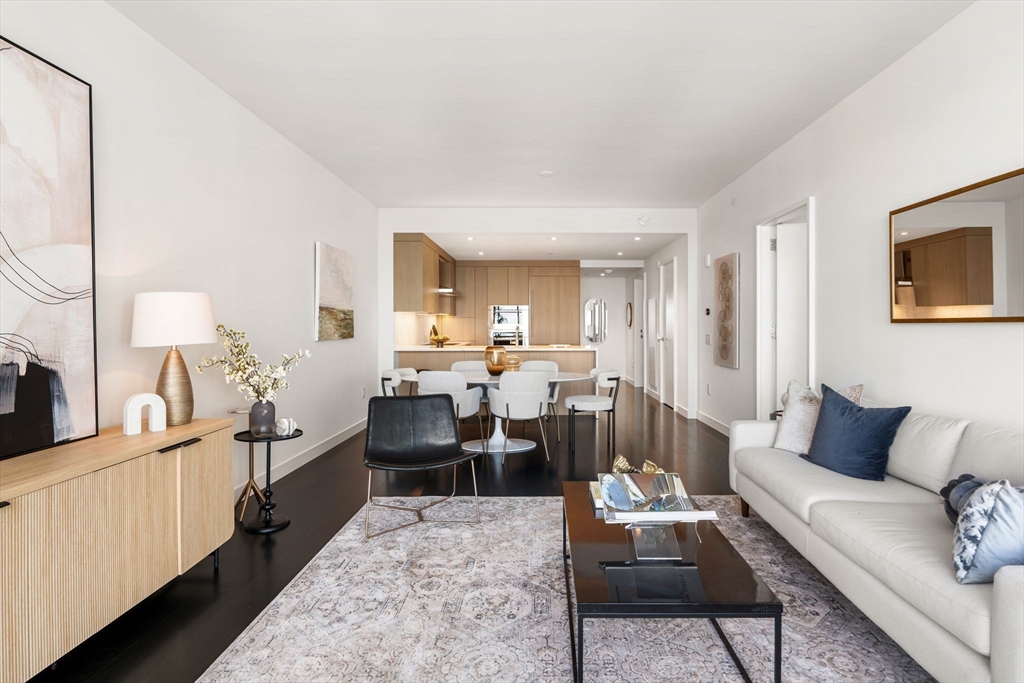150 Seaport, Unit 9C Boston, MA 02210 - Photo 7 of 39 a living room with furniture a rug and a lamp