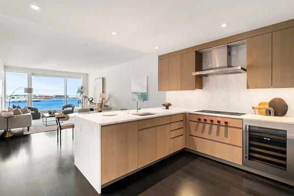 a kitchen with a sink cabinets and wooden floor