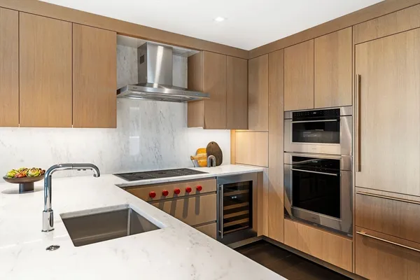 a kitchen with stainless steel appliances a stove a microwave and cabinets
