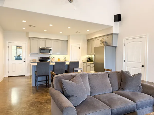 a living room with furniture and kitchen view