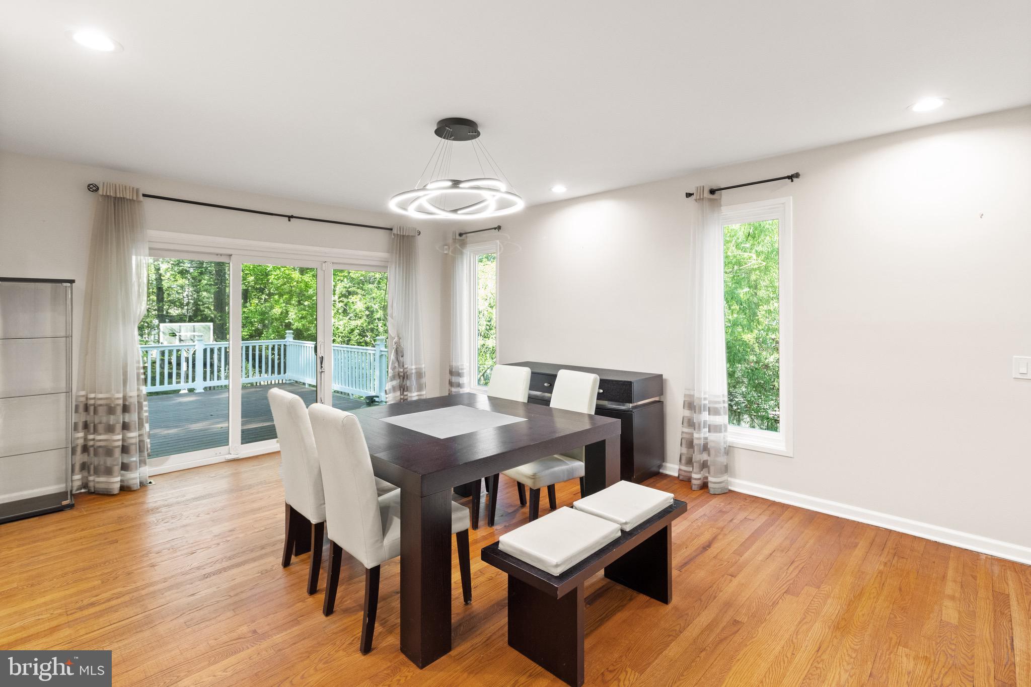 9220 Beech Hill Drive Bethesda, MD 20817 - Photo 12 of 50 a view of a dining room with furniture wooden floor and chandelier