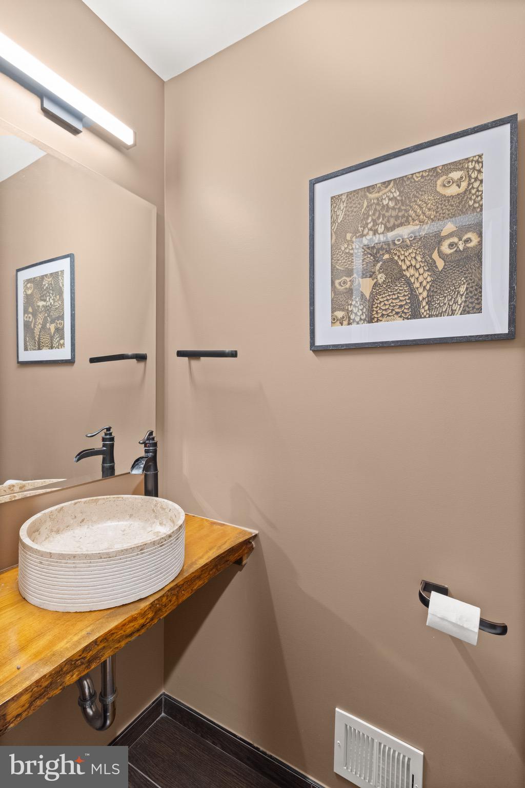 9220 Beech Hill Drive Bethesda, MD 20817 - Photo 17 of 50 a bathroom with a sink a mirror and a toilet