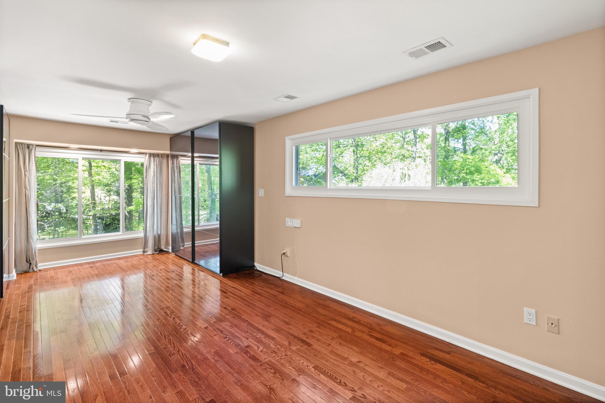 9220 Beech Hill Drive Bethesda, MD 20817 - Photo 20 of 50 a view of an empty room with wooden floor and a window