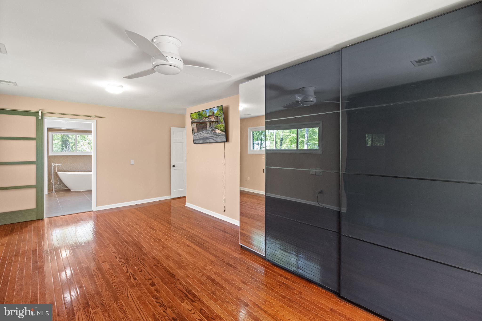 9220 Beech Hill Drive Bethesda, MD 20817 - Photo 23 of 50 an empty room with wooden floor and windows