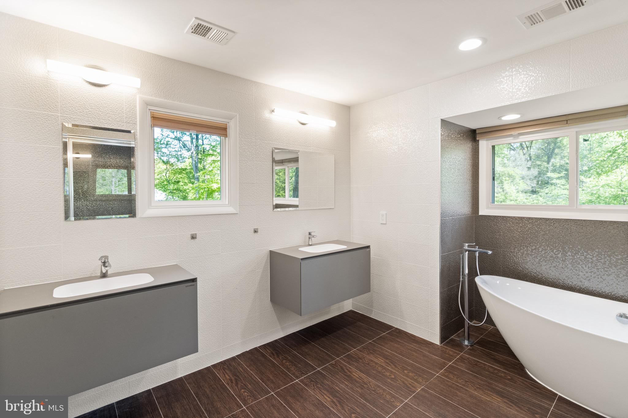9220 Beech Hill Drive Bethesda, MD 20817 - Photo 24 of 50 a bathroom with a double vanity sink a mirror and a bathtub