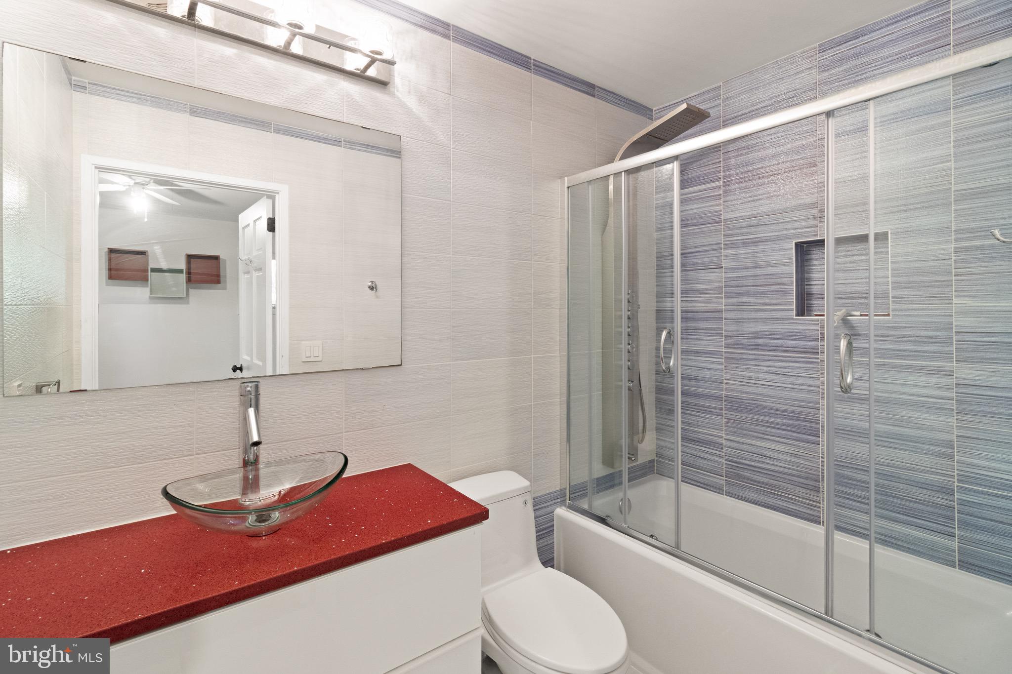 9220 Beech Hill Drive Bethesda, MD 20817 - Photo 32 of 50 a bathroom with a sink toilet and shower