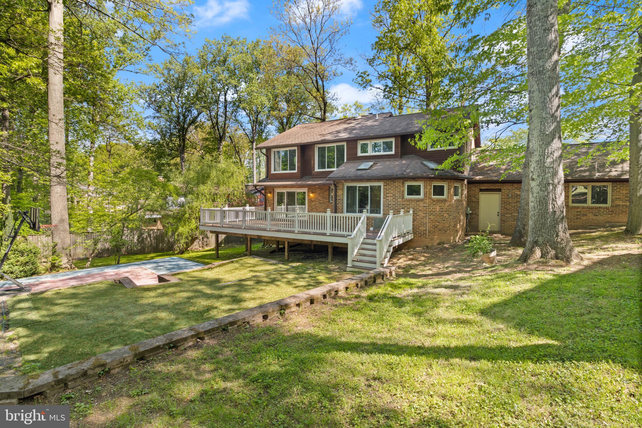 9220 Beech Hill Drive Bethesda, MD 20817 - Photo 49 of 50 a front view of a house with a yard table and chairs