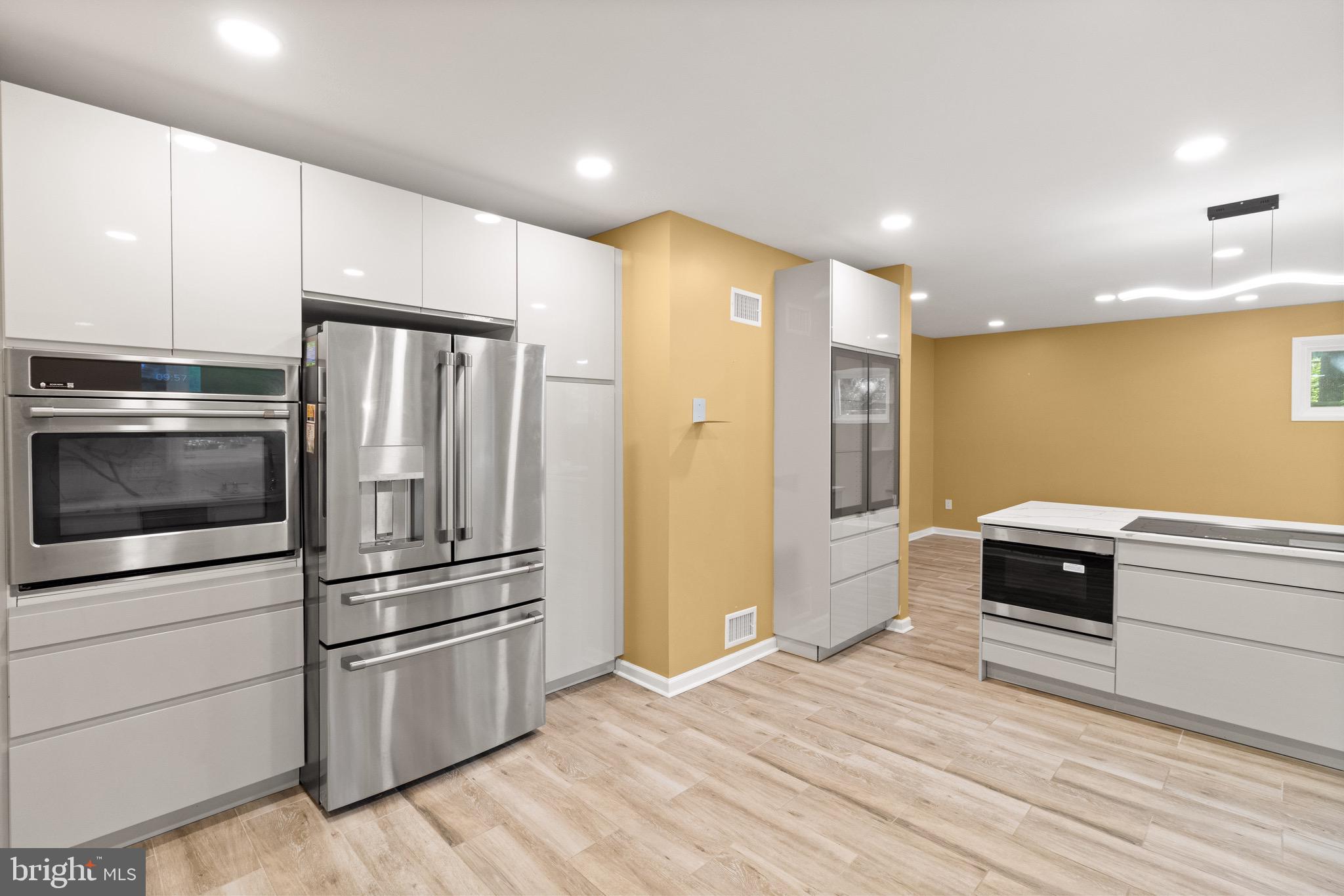 9220 Beech Hill Drive Bethesda, MD 20817 - Photo 6 of 50 a kitchen with a refrigerator and a stove top oven