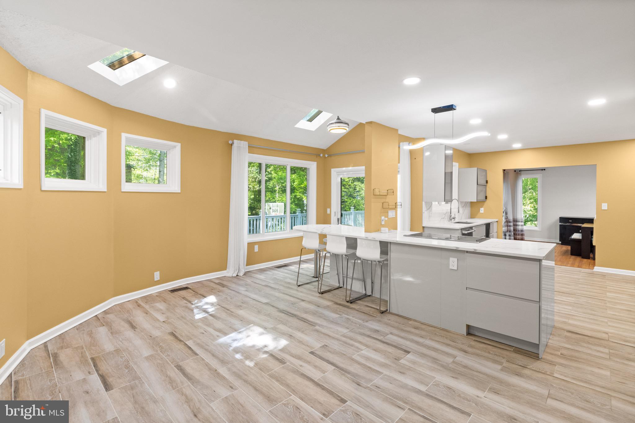 9220 Beech Hill Drive Bethesda, MD 20817 - Photo 7 of 50 a kitchen with stainless steel appliances granite countertop a stove a sink dishwasher and a dining table with wooden floor