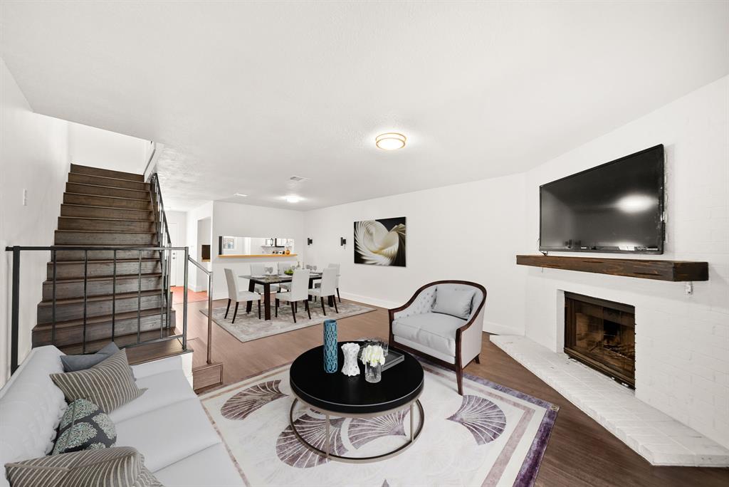 88 Winchester Drive Euless, TX 76039 - Photo 1 of 1 a living room with furniture a flat screen tv and a fireplace